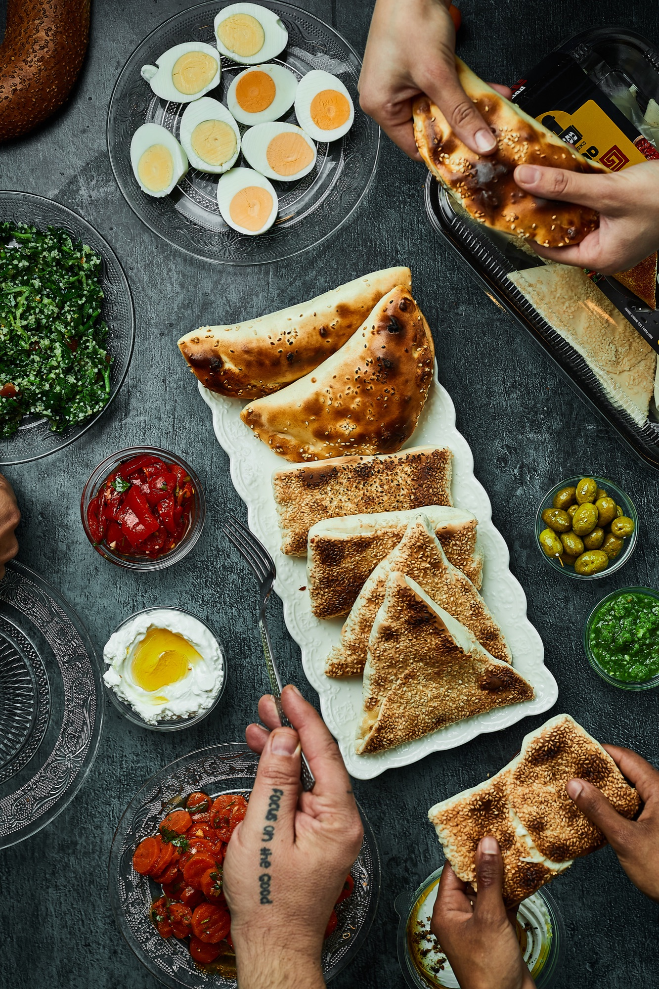 A spread of TABUNA breads and pastries on an open table